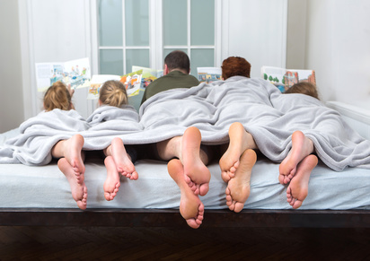 Feet of a family in bed ,